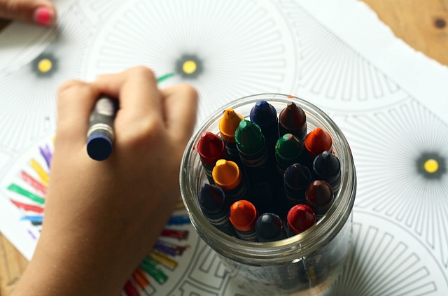 a child's hand coloring an intricate geometric coloring page a child's hand coloring an intricate geometric coloring page