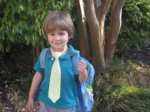 A young boy wearing a tie, ready to go back to school