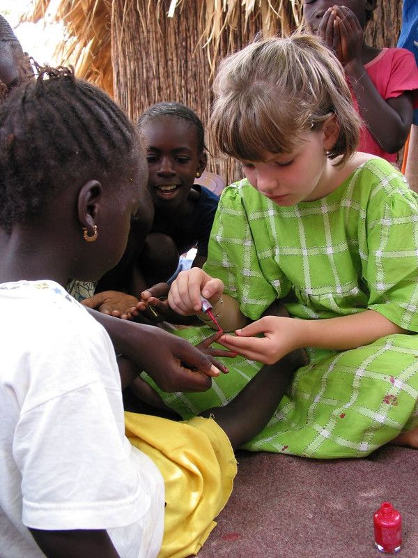 Meredith Queen paints her friend's nails in a Senegal village
